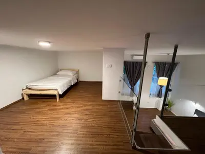 a bedroom with a bed and a wooden floor at Absolutum Apartments in Ljubljana