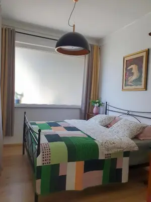 a bedroom with a bed with a colorful blanket at Apartment with Terrace Nona Pavla in Tolmin