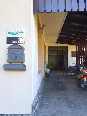 a building with a stove on the side of it at Apartment with Terrace Nona Pavla in Tolmin