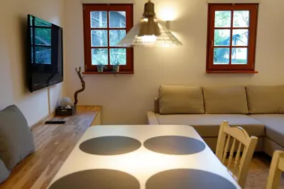 a living room with a table and a couch at Kota27 in Bovec