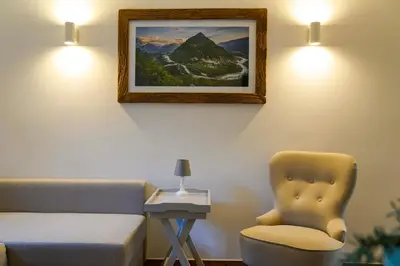 a bedroom with a bed and a chair and a picture at Kota27 in Bovec