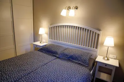 a bedroom with a blue bed with two night stands at Kota27 in Bovec