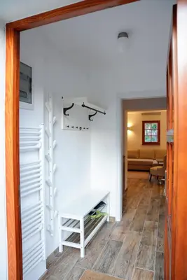 a hallway with white shelving and a white table at Kota27 in Bovec