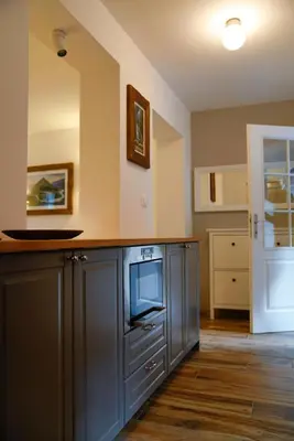 a kitchen with gray cabinets and a tv on a counter at Kota27 in Bovec