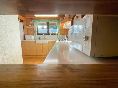 a kitchen with a large white counter top in a room at Dwarfs cabin overlooking Julian Alps near Bled in Jesenice