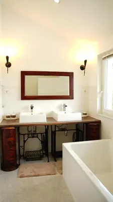 a bathroom with two sinks and a tub and a mirror at Sofia Holiday Haven in Nature with Pool in Slovenska Bistrica
