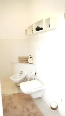 a white bathroom with a toilet and a sink at Sofia Holiday Haven in Nature with Pool in Slovenska Bistrica