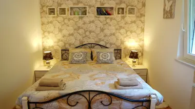 a bedroom with a bed with two night stands at Sofia Holiday Haven in Nature with Pool in Slovenska Bistrica