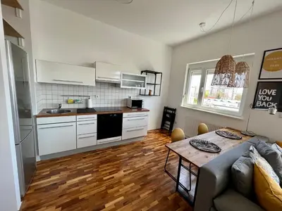 a kitchen and living room with a couch and a table at Condo Casa Di Olivia in Maribor