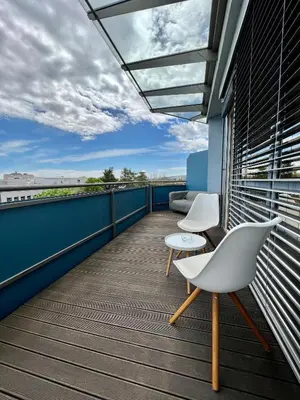 a balcony with two white chairs and a couch at Condo Casa Di Olivia in Maribor