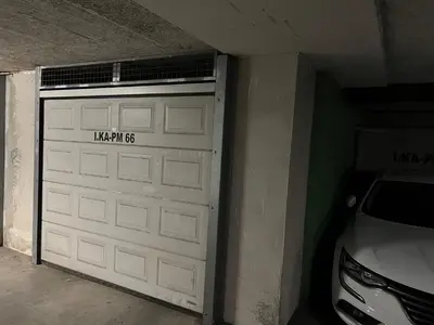 a garage door with a car parked next to it at Condo Casa Di Olivia in Maribor