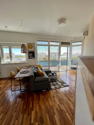 a living room with a couch and a table at Condo Casa Di Olivia in Maribor