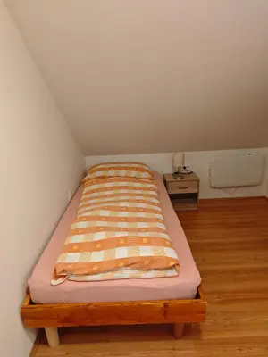 a bed in a small room with a bed sidx sidx sidx at Počitniška hišica Rogatec - Holiday Cottage Rogatec in Luče