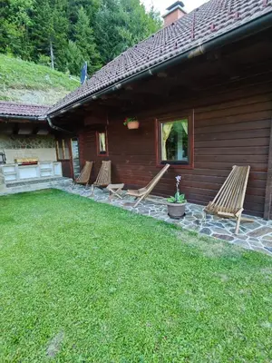 a group of chairs sitting outside of a house at Počitniška hišica Rogatec - Holiday Cottage Rogatec in Luče
