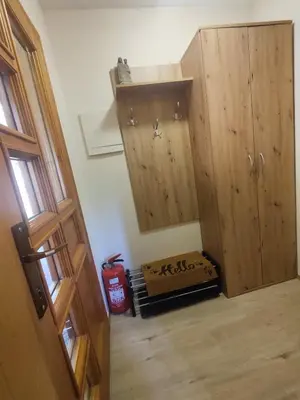 an attic room with a wooden door and a dog crate at Počitniška hišica Rogatec - Holiday Cottage Rogatec in Luče