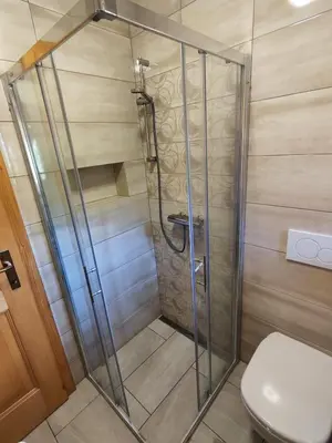 a shower stall in a bathroom with a toilet at Počitniška hišica Rogatec - Holiday Cottage Rogatec in Luče
