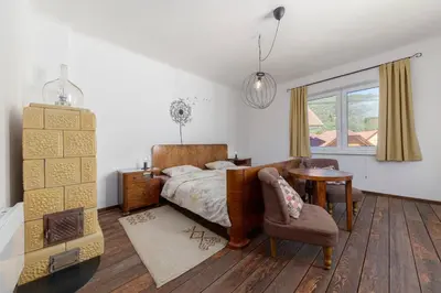 a bedroom with a bed and a table and a chair at DoLodge Homestead & Camper Parking Kolpa River Canyon in Stari Trg ob Kolpi