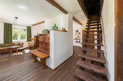 a living room with wooden floors and a staircase at DoLodge Homestead & Camper Parking Kolpa River Canyon in Stari Trg ob Kolpi