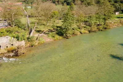 an aerial view of a river with green water at DoLodge Homestead & Camper Parking Kolpa River Canyon in Stari Trg ob Kolpi